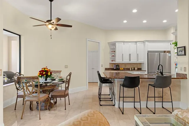 a view of a dining room with furniture and a chandelier