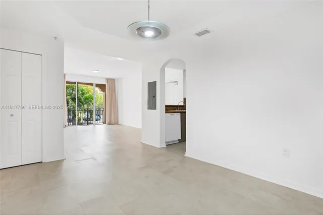 an empty room with windows and closet