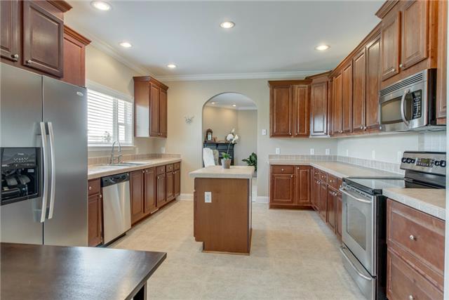 2250 Clara Mathis Road Spring Hill, TN 37174 - Photo 7 of 20 a kitchen with stainless steel appliances granite countertop a sink a stove and a refrigerator