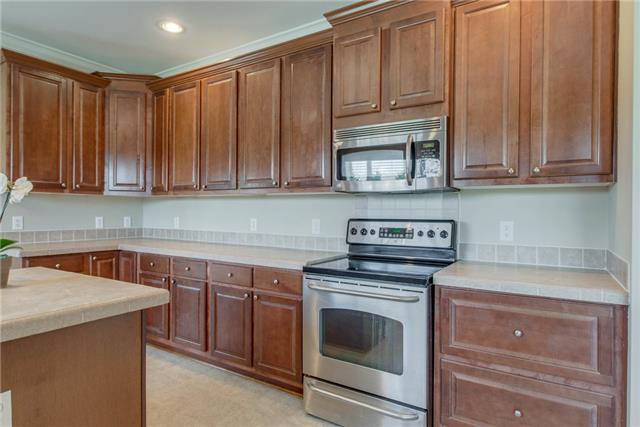 2250 Clara Mathis Road Spring Hill, TN 37174 - Photo 8 of 20 a kitchen with granite countertop cabinets stainless steel appliances and sink