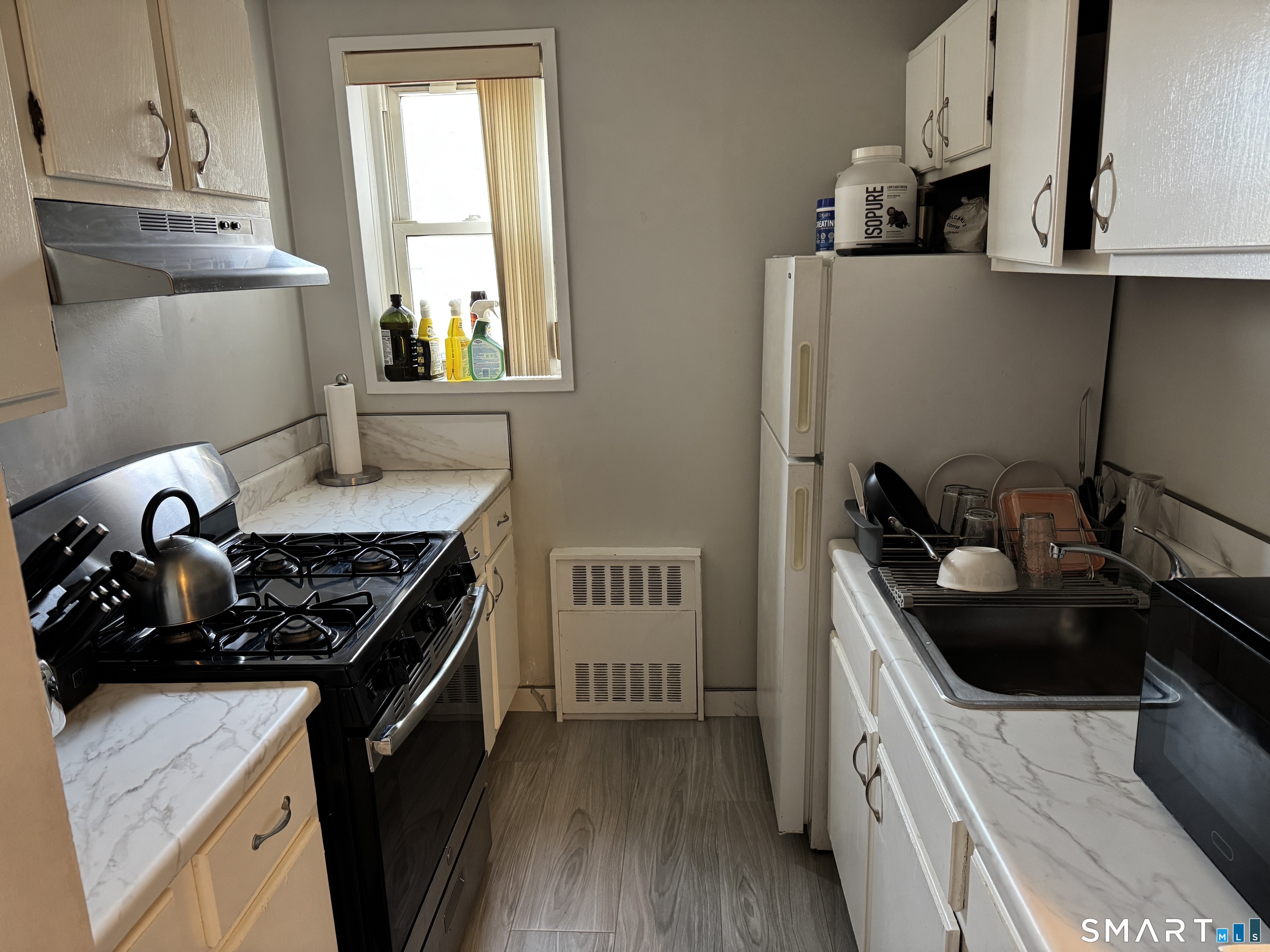 99 Prospect Street, Unit 7K Stamford, CT 06901 - Photo 12 of 25 a kitchen with a sink stove and refrigerator