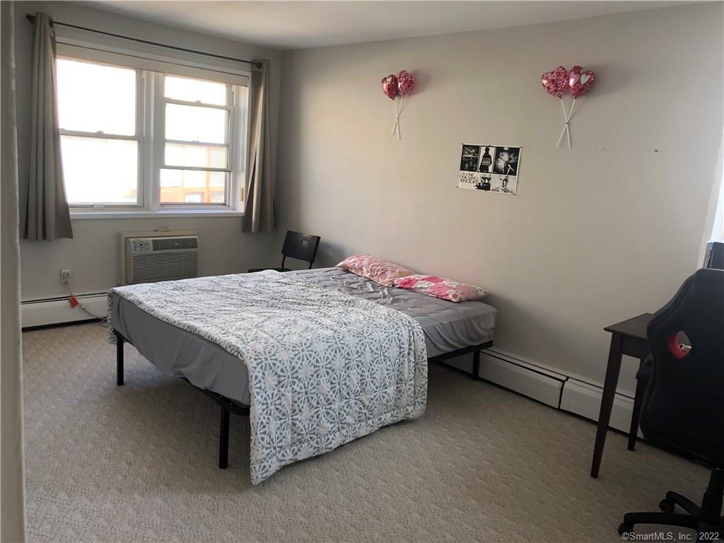 99 Prospect Street, Unit 7K Stamford, CT 06901 - Photo 14 of 25 a bed sitting in a bedroom next to a window