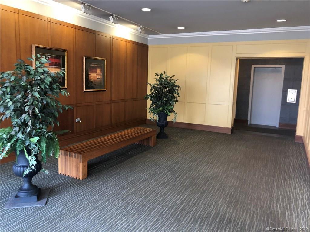 99 Prospect Street, Unit 7K Stamford, CT 06901 - Photo 4 of 25 a view of a room with wooden floor and a potted plant