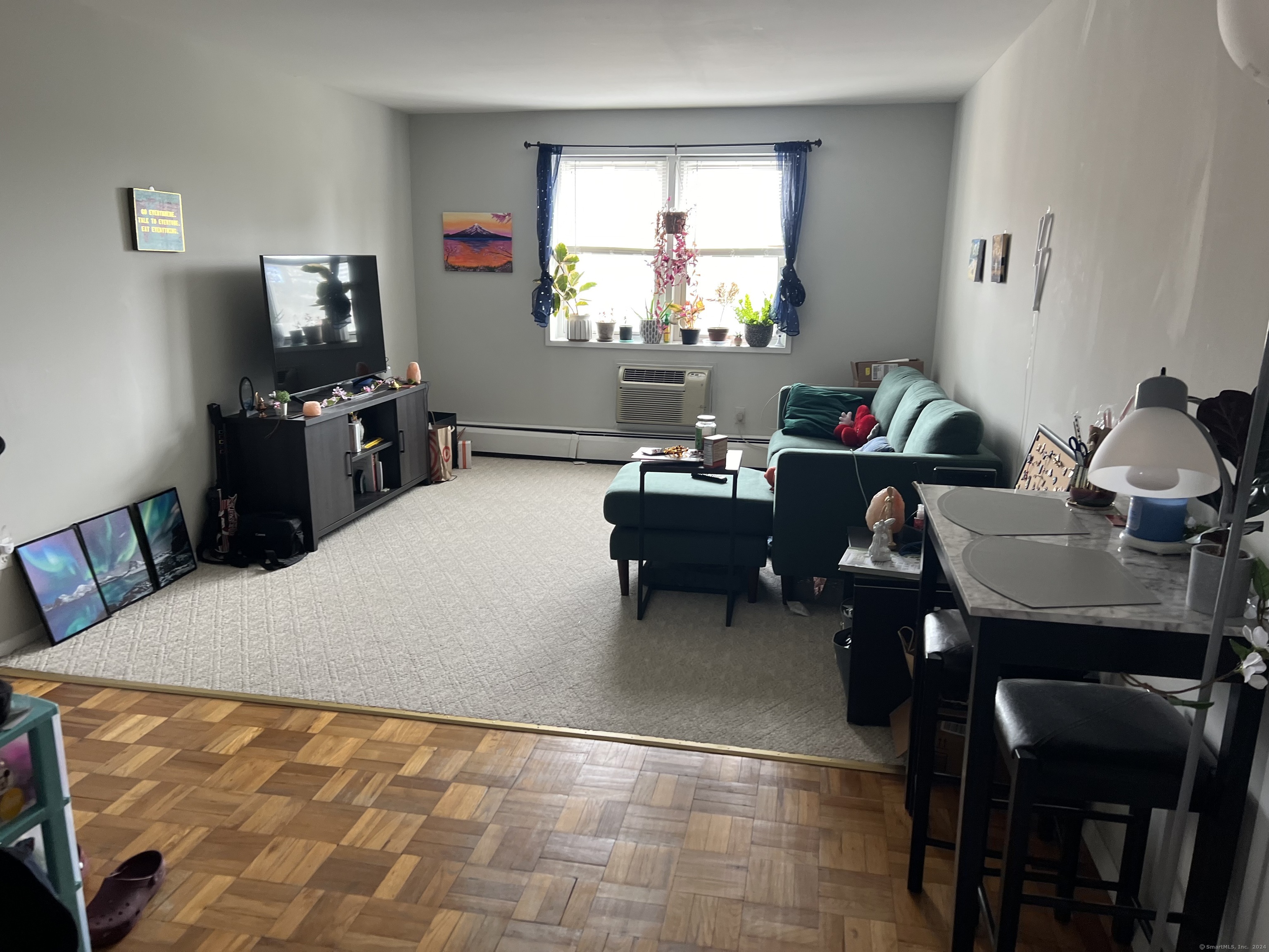 99 Prospect Street, Unit 7K Stamford, CT 06901 - Photo 8 of 25 a living room with furniture a window and a flat screen tv