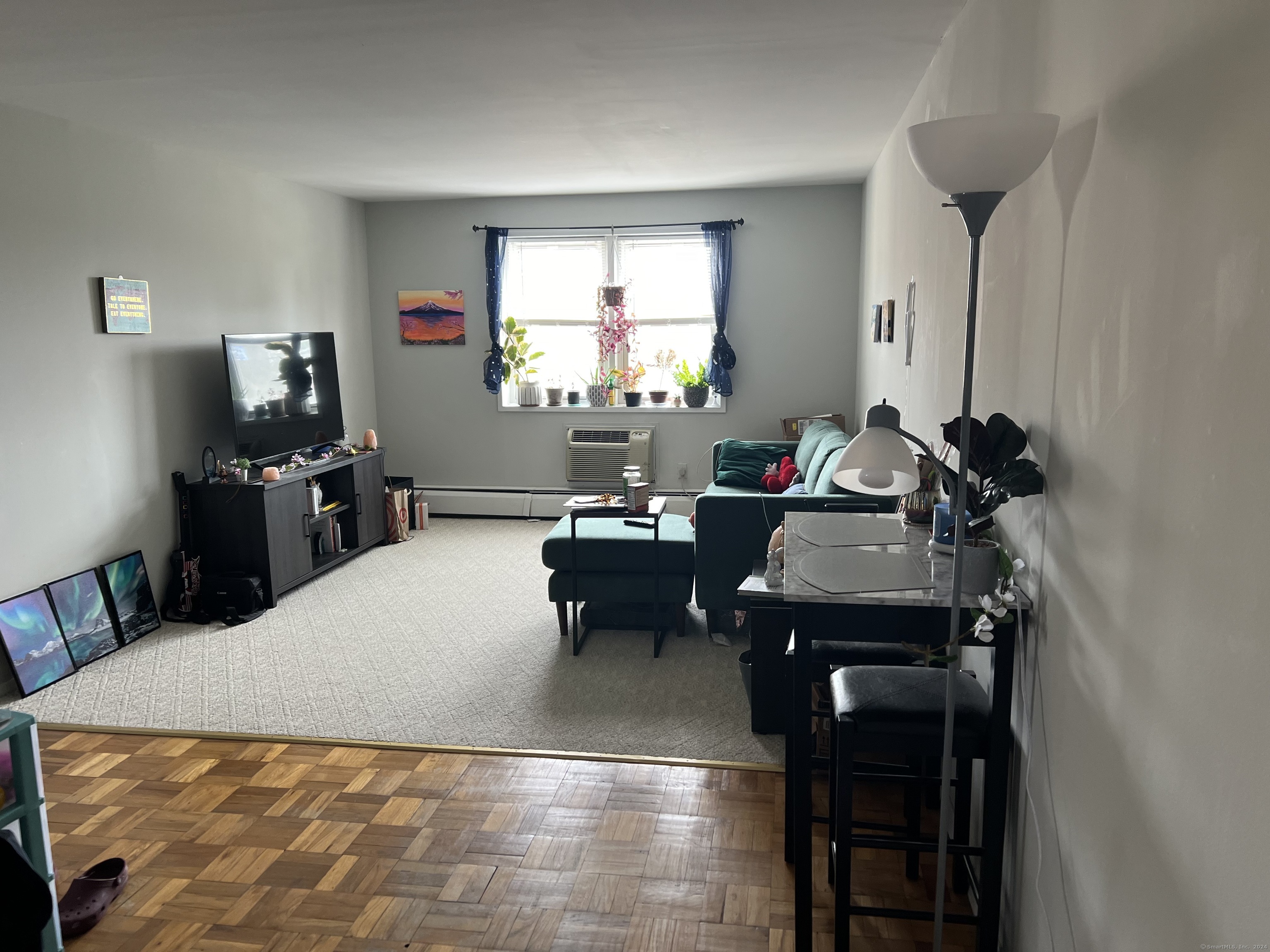 99 Prospect Street, Unit 7K Stamford, CT 06901 - Photo 10 of 25 a living room with furniture and a flat screen tv