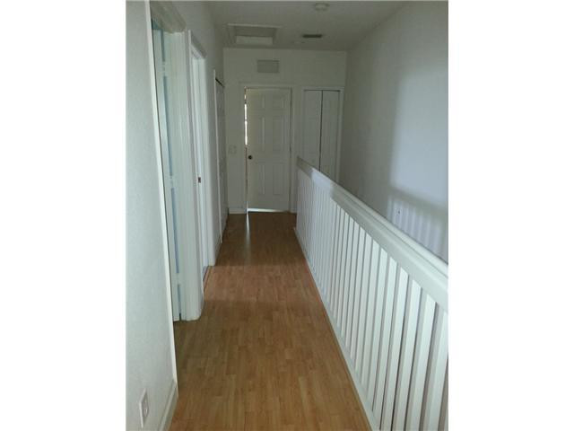 4103 Southwest 159th Avenue, Unit 49 Miramar, FL 33027 - Photo 19 of 20 a view of a hallway with wooden floor
