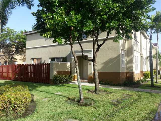 4103 Southwest 159th Avenue, Unit 49 Miramar, FL 33027 - Photo 4 of 20 a view of a house with a yard and large tree