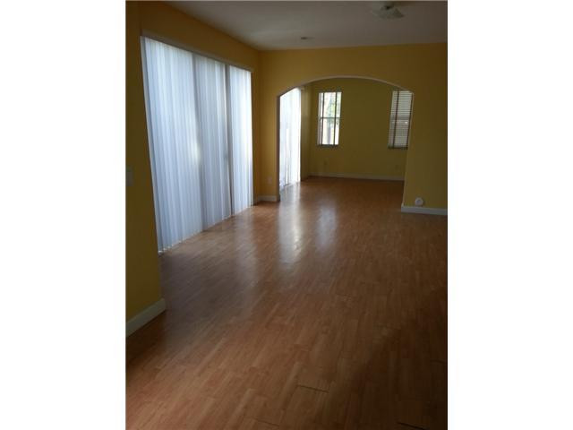 4103 Southwest 159th Avenue, Unit 49 Miramar, FL 33027 - Photo 5 of 20 a view of a room with wooden floor and windows