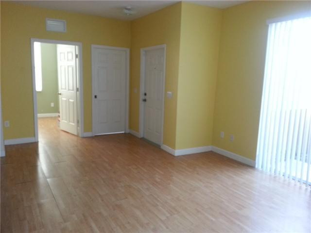 4103 Southwest 159th Avenue, Unit 49 Miramar, FL 33027 - Photo 6 of 20 a view of an empty room with wooden floor