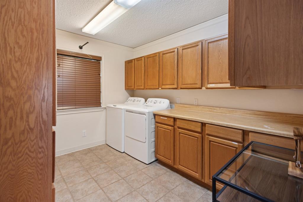 227 Scenic Road Trinidad, TX 75163 - Photo 23 of 40 a utility room with cabinets washer and dryer