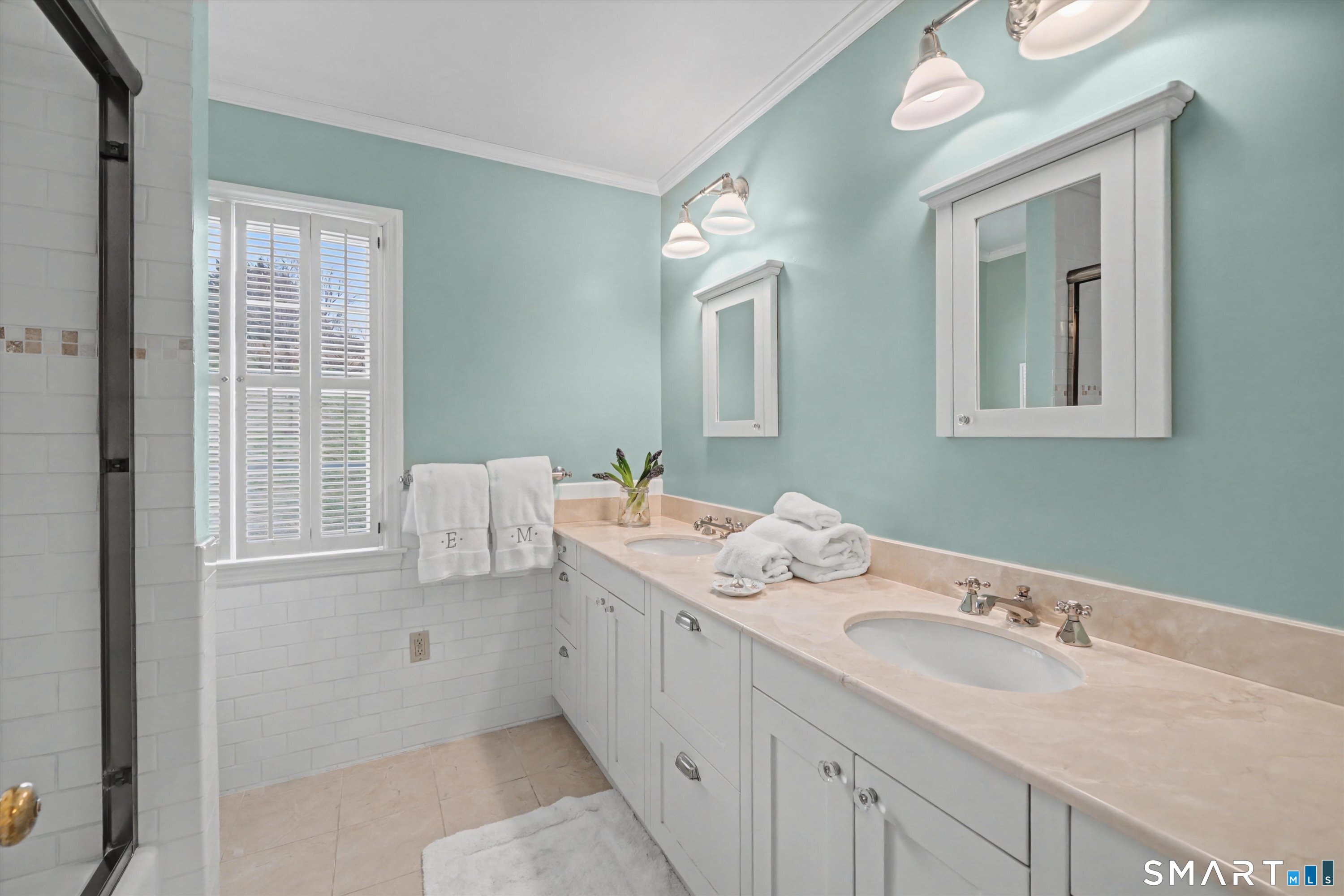 78 Keelers Ridge Road Wilton, CT 06897 - Photo 28 of 40 a bathroom with a double vanity sink and mirror with window