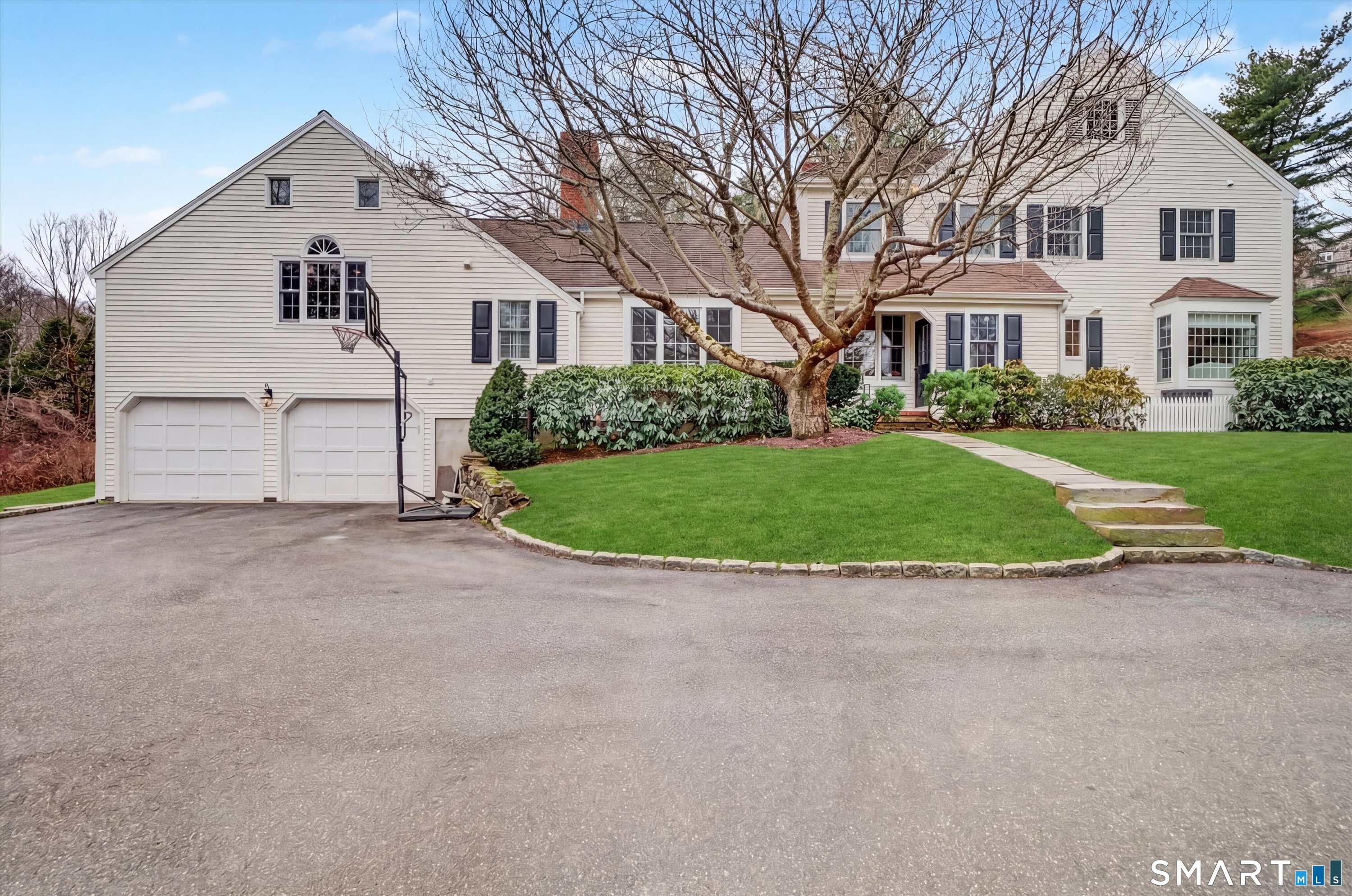 78 Keelers Ridge Road Wilton, CT 06897 - Photo 36 of 40 a view of white house with a yard and garage