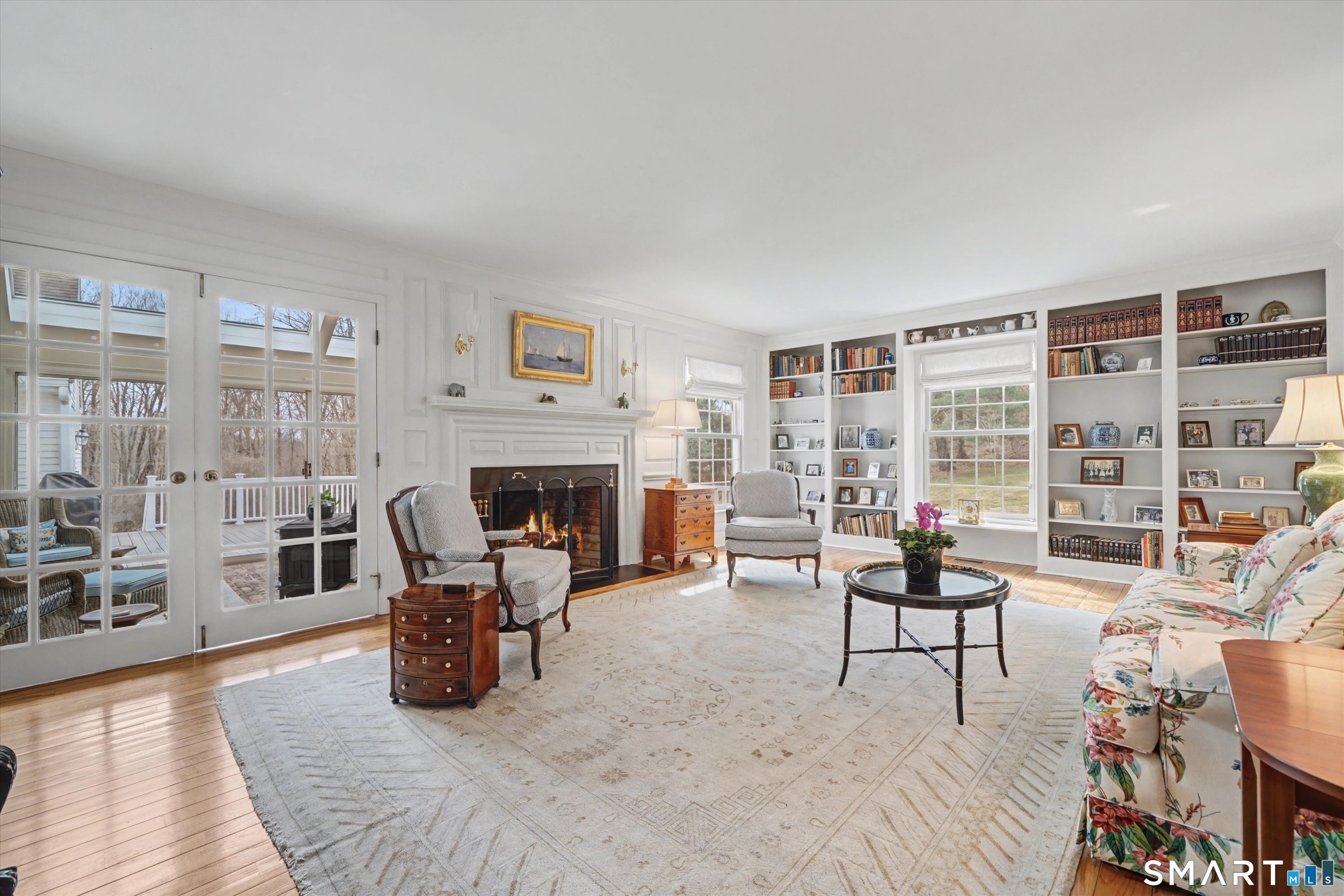 78 Keelers Ridge Road Wilton, CT 06897 - Photo 5 of 40 a living room with furniture a fireplace and a floor to ceiling window