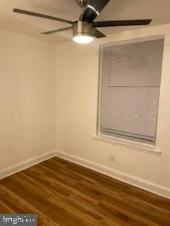 a view of a small space with wooden floor and a window