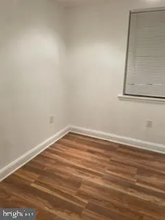a view of a room with wooden floor and cabinet