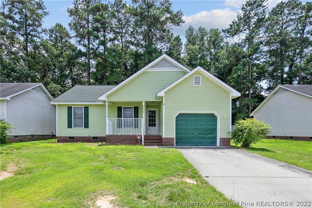6405 Rhemish Drive Fayetteville, NC 28304 - Photo 1 of 21 a front view of a house with a garden and yard