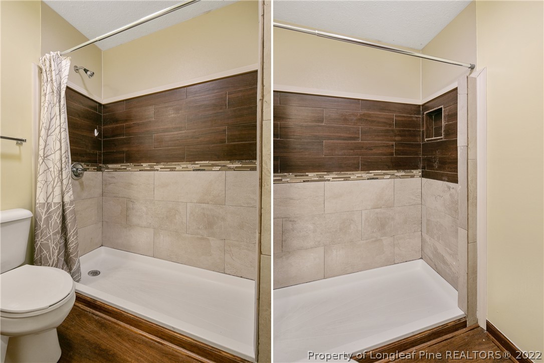 6405 Rhemish Drive Fayetteville, NC 28304 - Photo 12 of 21 a bathroom with a bathtub and a shower