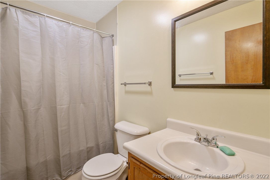 6405 Rhemish Drive Fayetteville, NC 28304 - Photo 16 of 21 a bathroom with a sink and a mirror