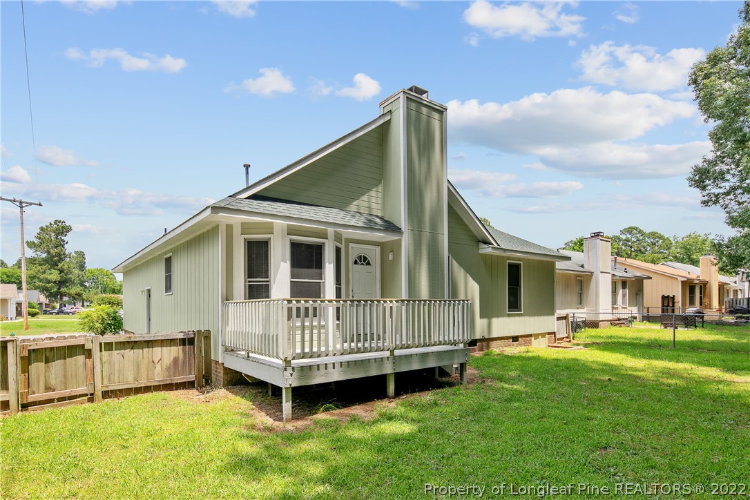 6405 Rhemish Drive Fayetteville, NC 28304 - Photo 21 of 21 a view of a house with a backyard and deck