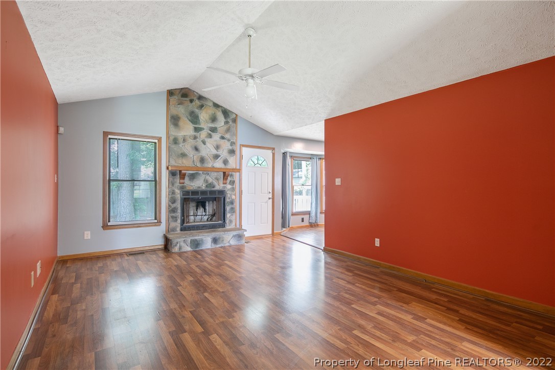 6405 Rhemish Drive Fayetteville, NC 28304 - Photo 4 of 21 a view of a livingroom with wooden floor and a ceiling fan