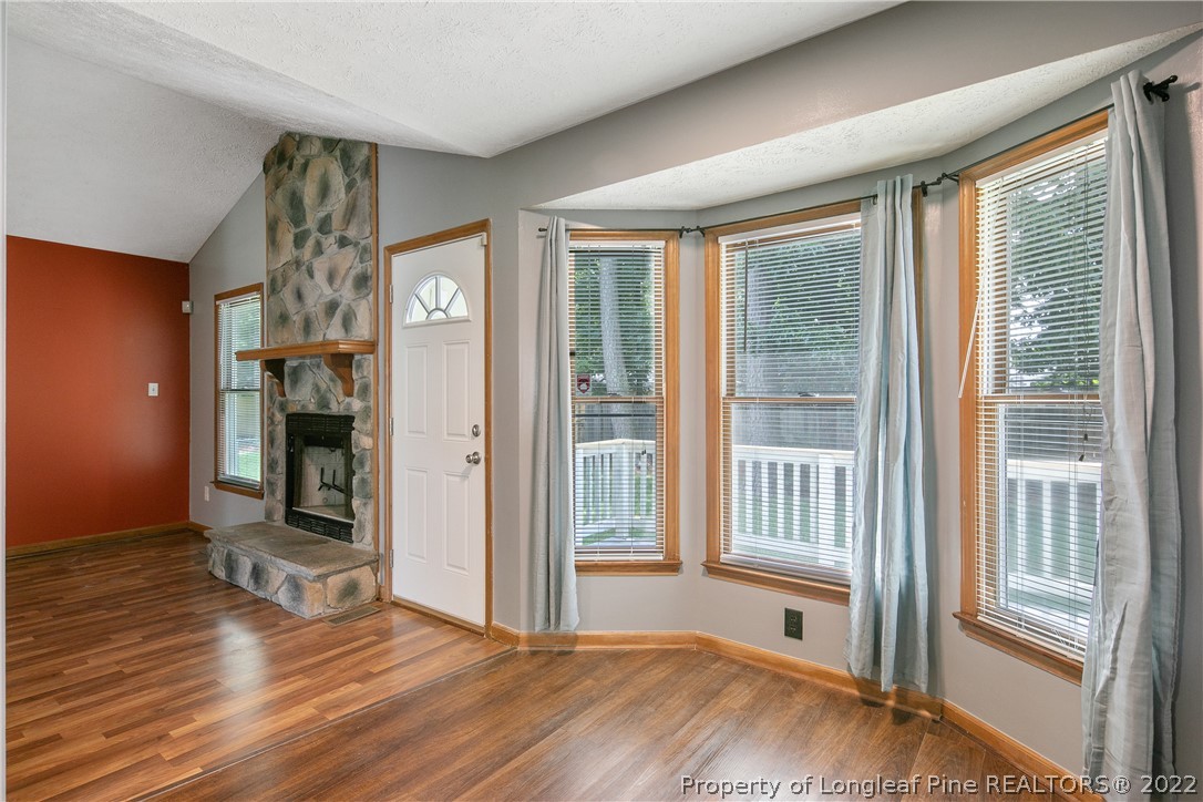 6405 Rhemish Drive Fayetteville, NC 28304 - Photo 8 of 21 a view of an empty room with wooden floor and a window