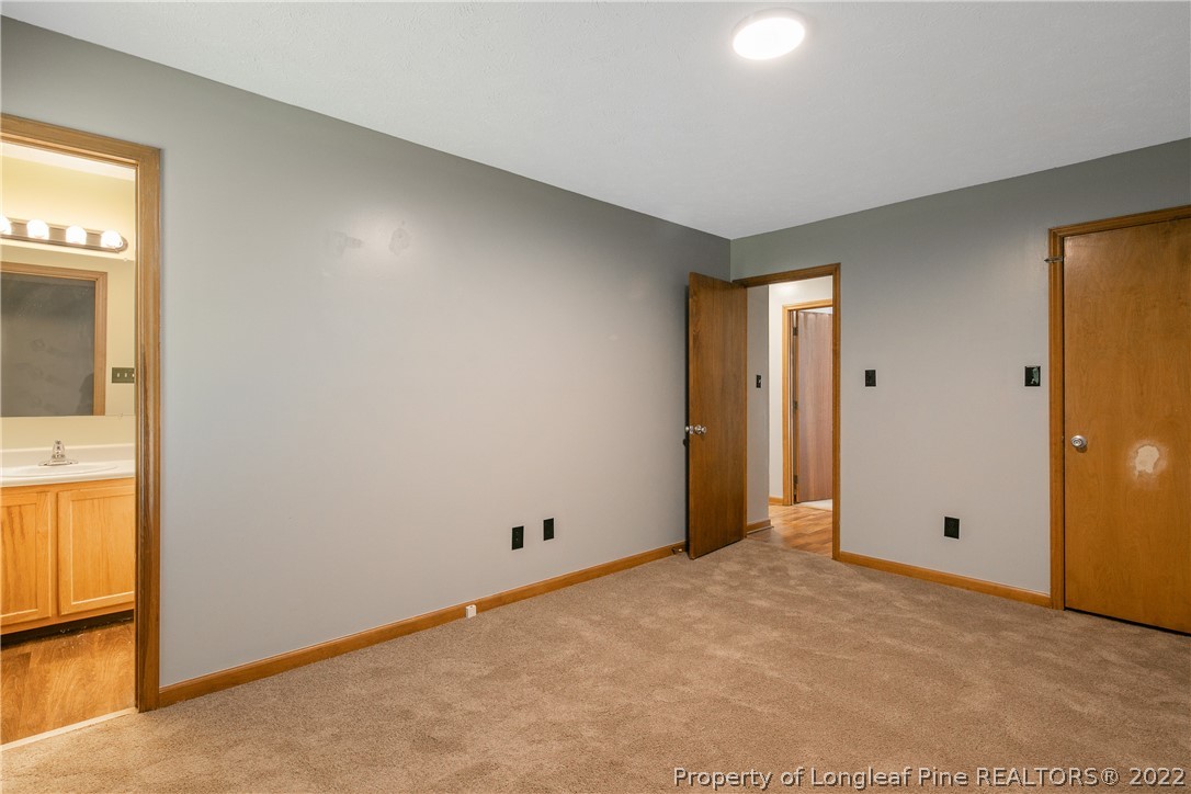 6405 Rhemish Drive Fayetteville, NC 28304 - Photo 10 of 21 an empty room with mirror