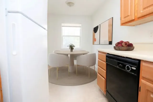 a kitchen with a table and chairs in it