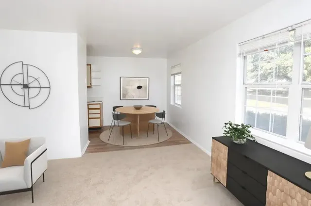 a living room with furniture a window and a chandelier