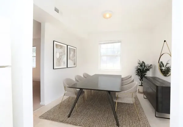 a dining room with furniture and window