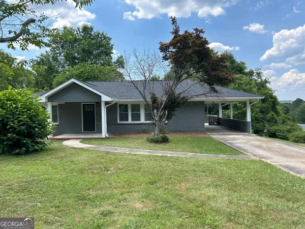 a front view of house with yard and green space