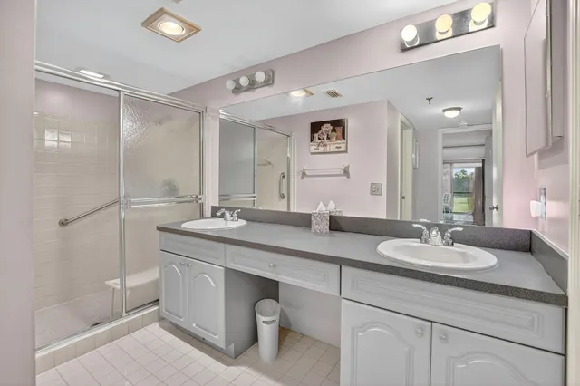 a bathroom with double sink and a mirror