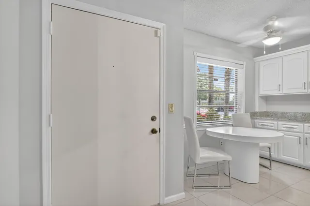 a kitchen with a sink cabinets and chairs