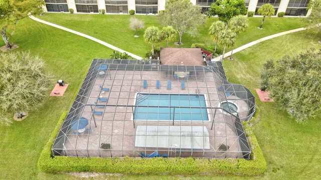 an aerial view of a house with a yard basket ball court and outdoor seating