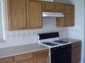 a kitchen with a stove and a microwave