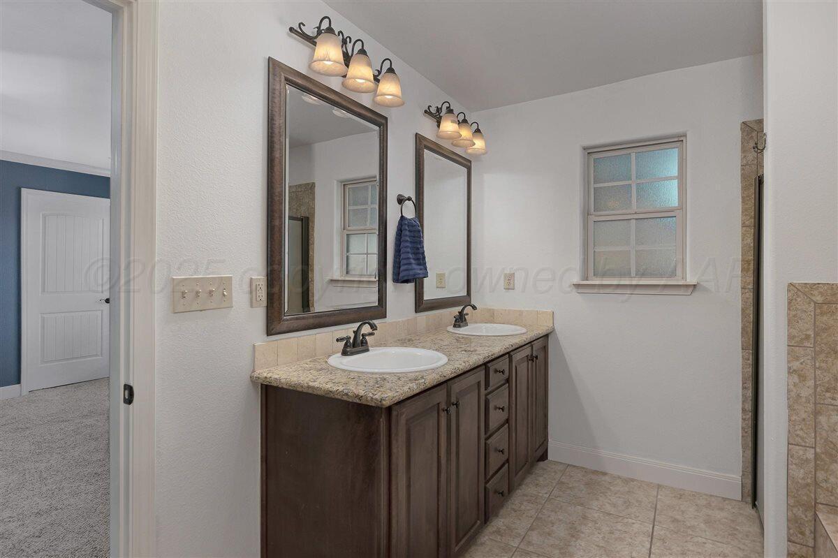 22 Sandra Lane Canyon, TX 79015 - Photo 17 of 25 a bathroom with a granite countertop sink and a mirror