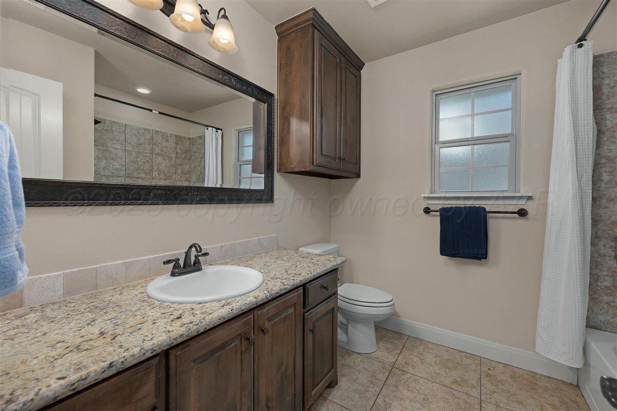 22 Sandra Lane Canyon, TX 79015 - Photo 21 of 25 a bathroom with a granite countertop sink a toilet and mirror