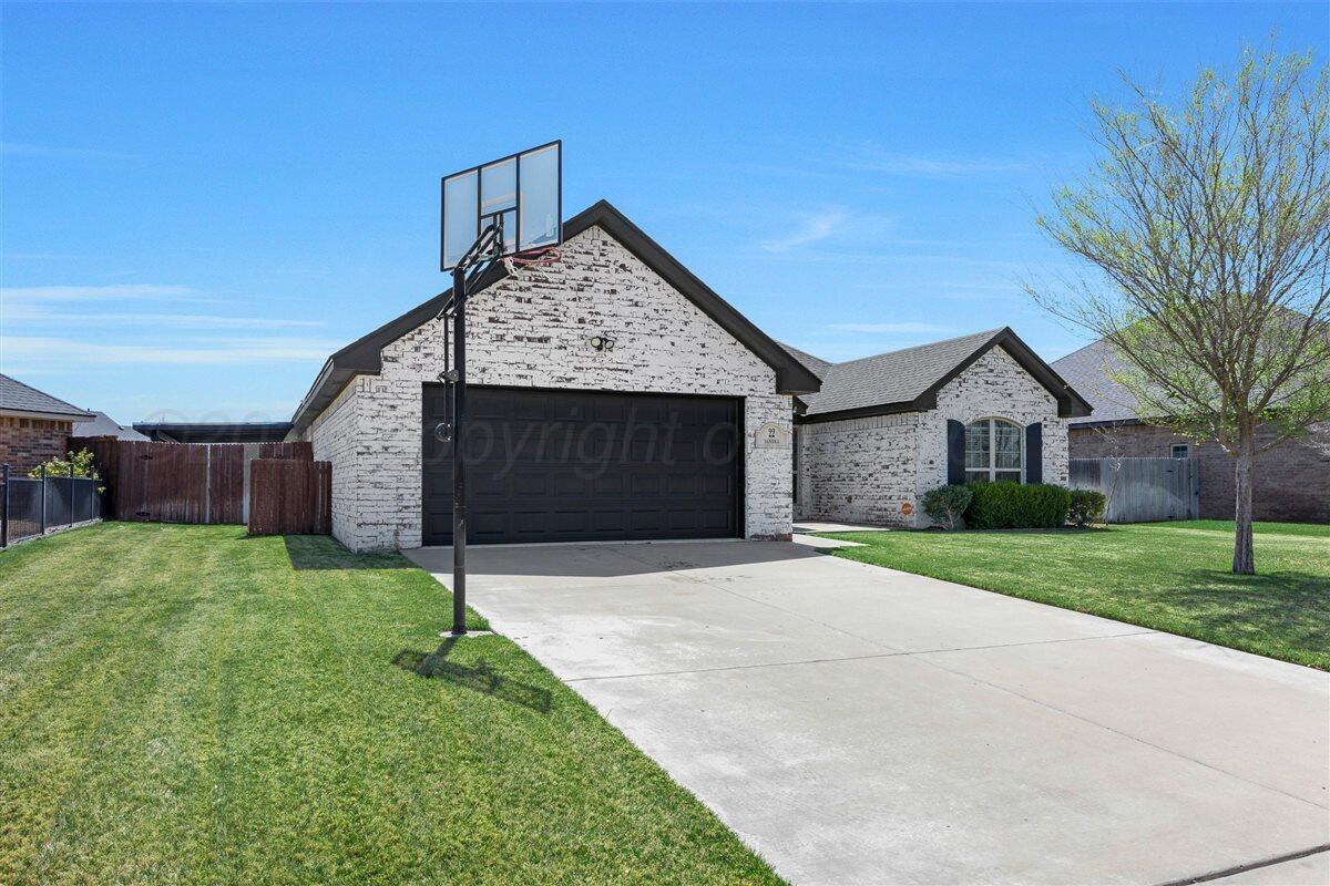 22 Sandra Lane Canyon, TX 79015 - Photo 6 of 25 a front view of a house with a yard and garage