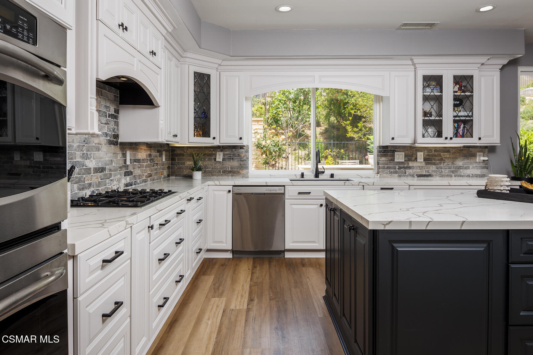 5859 Evening Sky Drive Simi Valley, CA 93063 - Photo 14 of 50 a kitchen with granite countertop a sink stove and cabinets