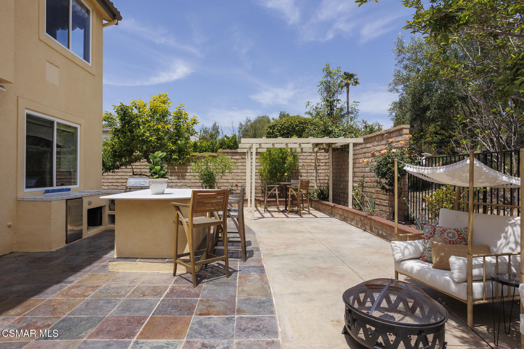5859 Evening Sky Drive Simi Valley, CA 93063 - Photo 40 of 50 a view of a patio with dining table and chairs with a small yard