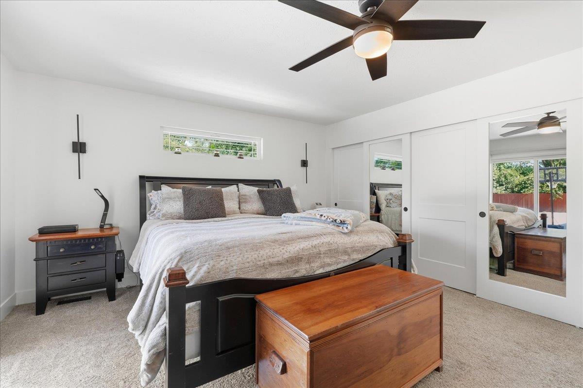 4849 Alexon Way Carmichael, CA 95608 - Photo 32 of 50 a bedroom with a bed and a chandelier