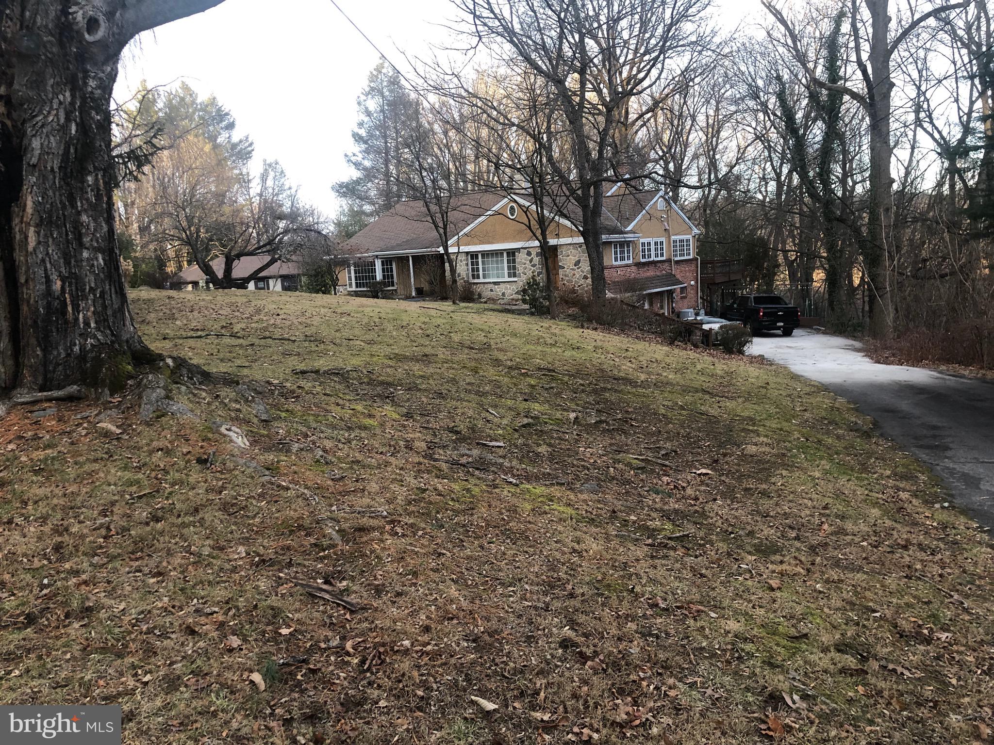 351 Hidden River Road Penn Valley, PA 19072 - Photo 3 of 48 a front view of a house with a yard covered with snow