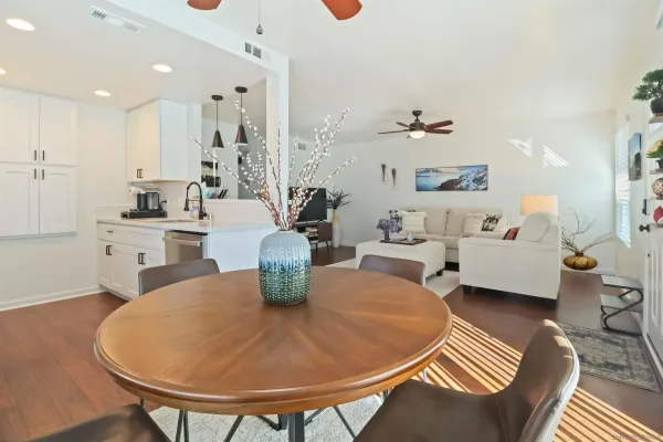 a living room with dining room and wooden furniture