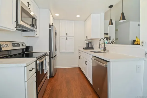a kitchen with a sink stove and refrigerator