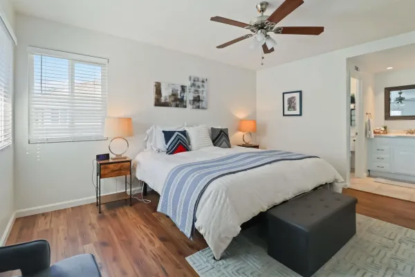 a bedroom with bed and a window