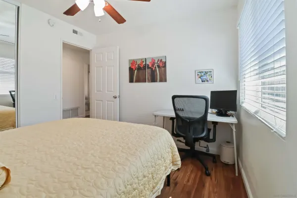 a bedroom with a bed and a chair