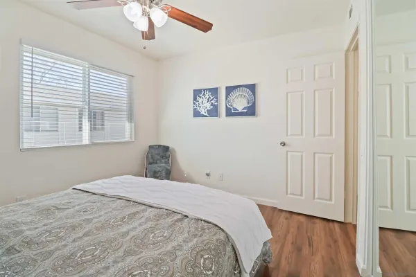 a bedroom with a large bed and a window