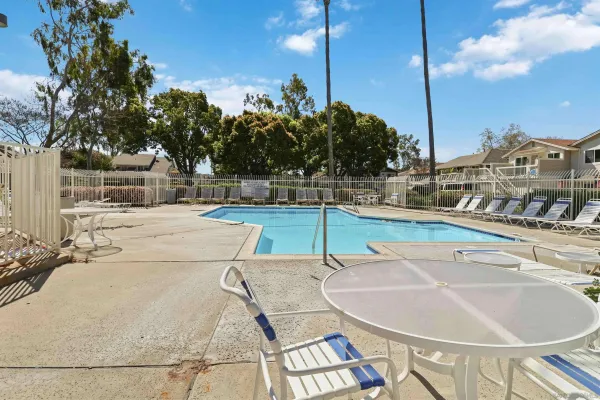 a swimming pool with outdoor seating and yard
