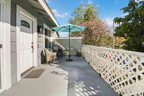 a view of a patio with table and chairs with wooden fence and plants