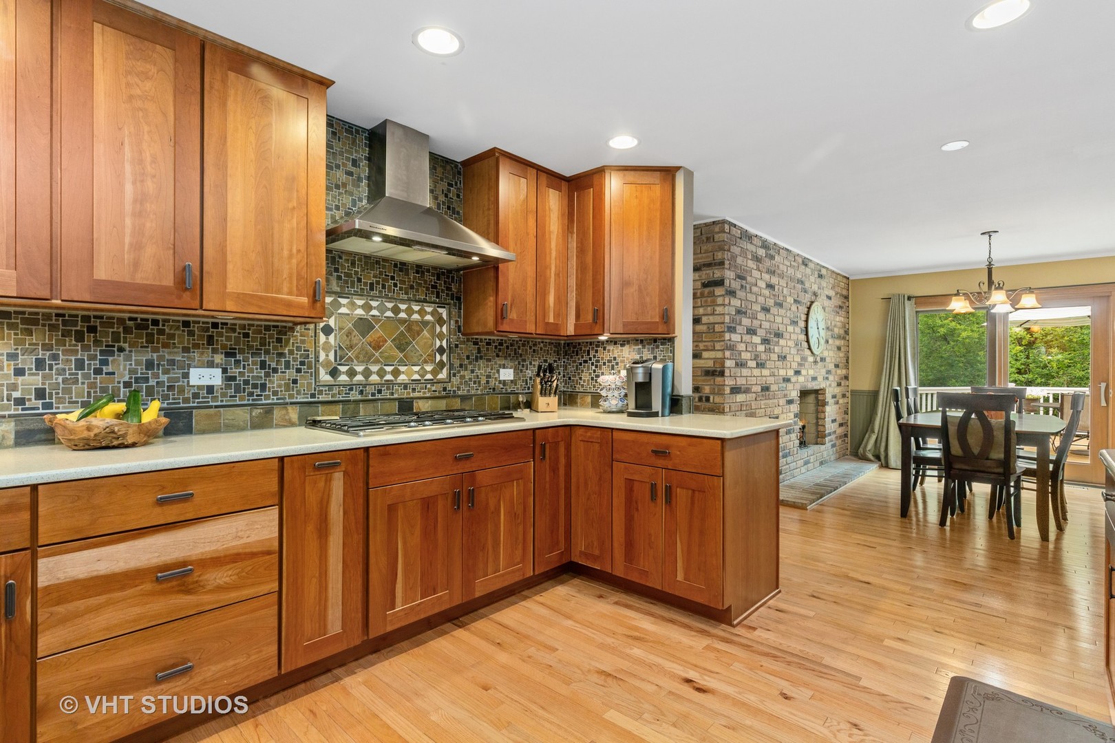 25287 Wren Road Tower Lakes, IL 60010 - Photo 13 of 51 a kitchen with stainless steel appliances granite countertop wooden cabinets a dining table and chairs