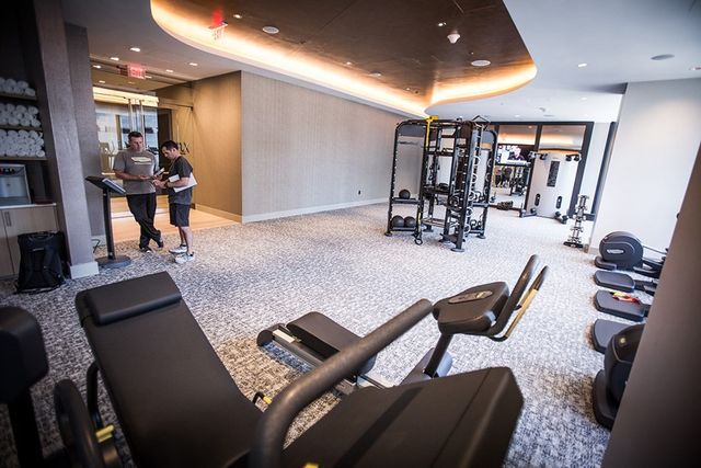 a workspace with furniture and a large window